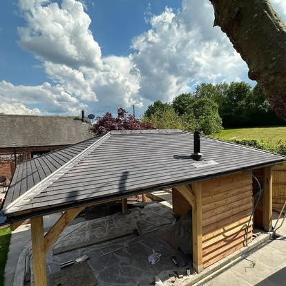 New-build hip roof on a garden outbuilding finished with slate-grey tiles by Matt Merry Roofing, Hinckley