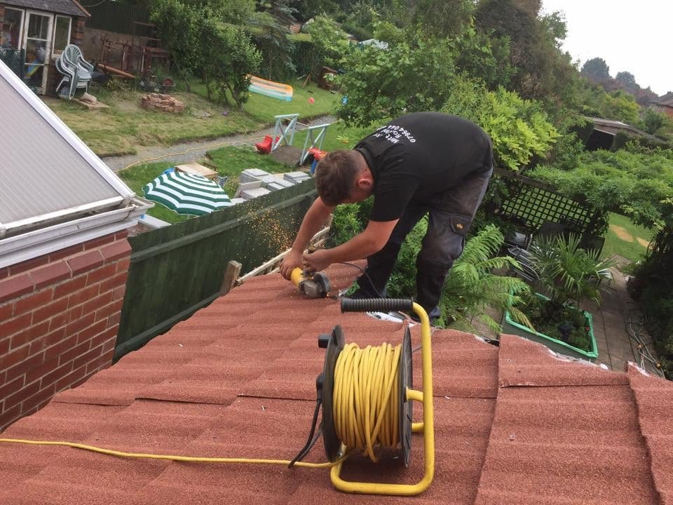 Matt Merry Roofing cutting a tile with an angle grinder while working on a tiled roof in Hinckley